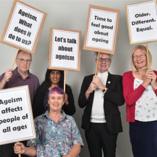 5 people holding up placards with slogans about ageism