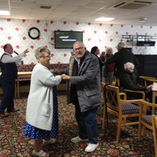 Older man and woman dancing together