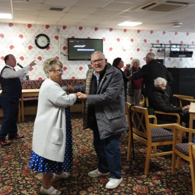 Older man and woman dancing together