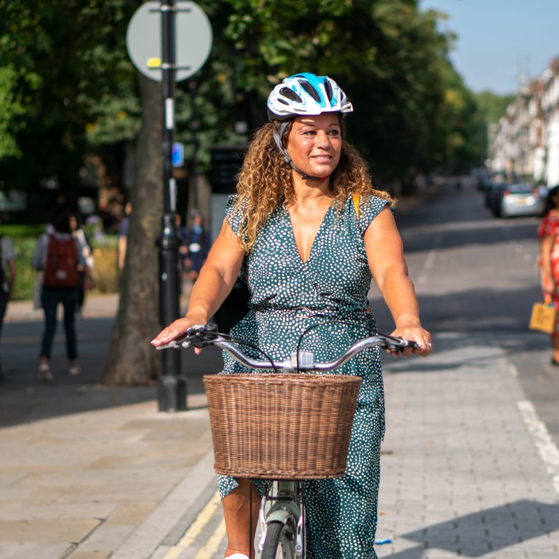 Woman relaxed cycling in a town