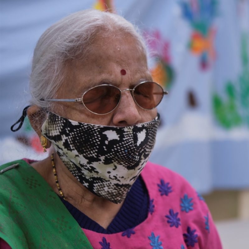 Older South Asian woman wearing a mask