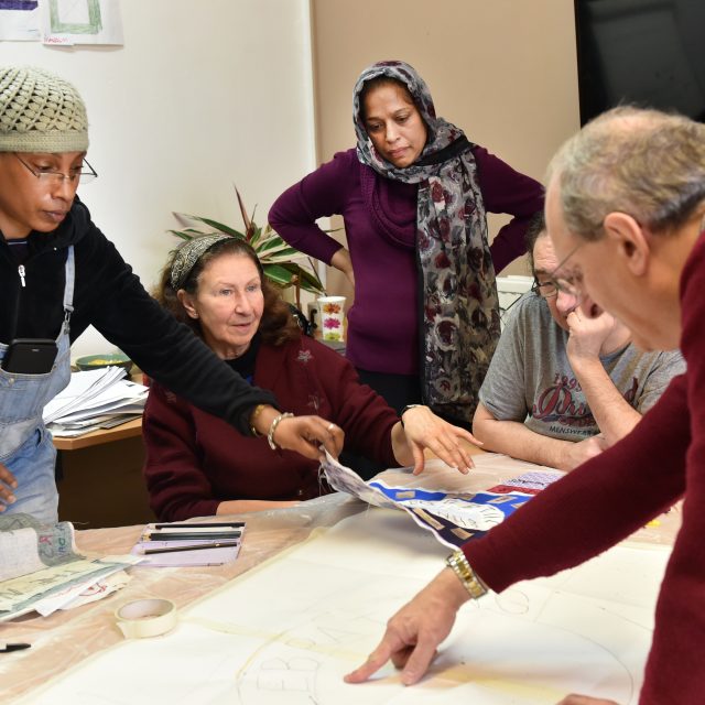 Small group of older people working together at a table