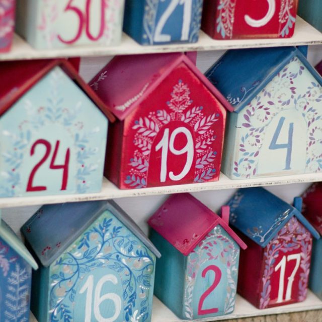 Little 3d houses on shelves, with numbers on them