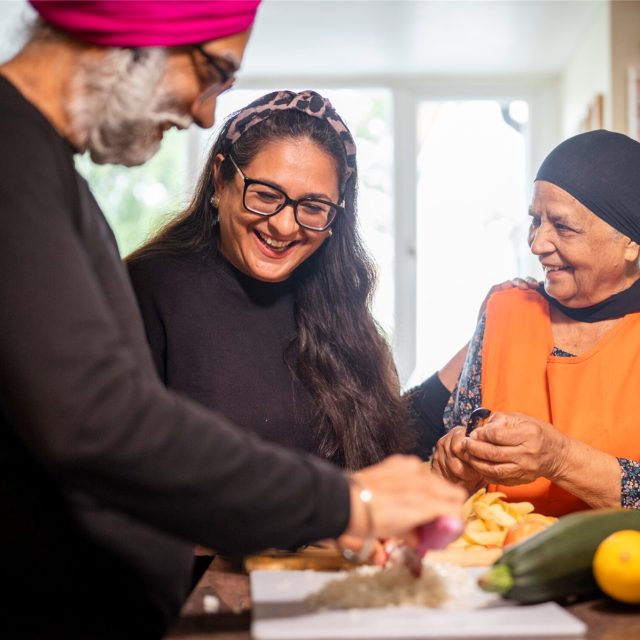 Man and two women preparing food together