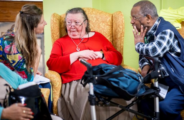 Three older people talking together