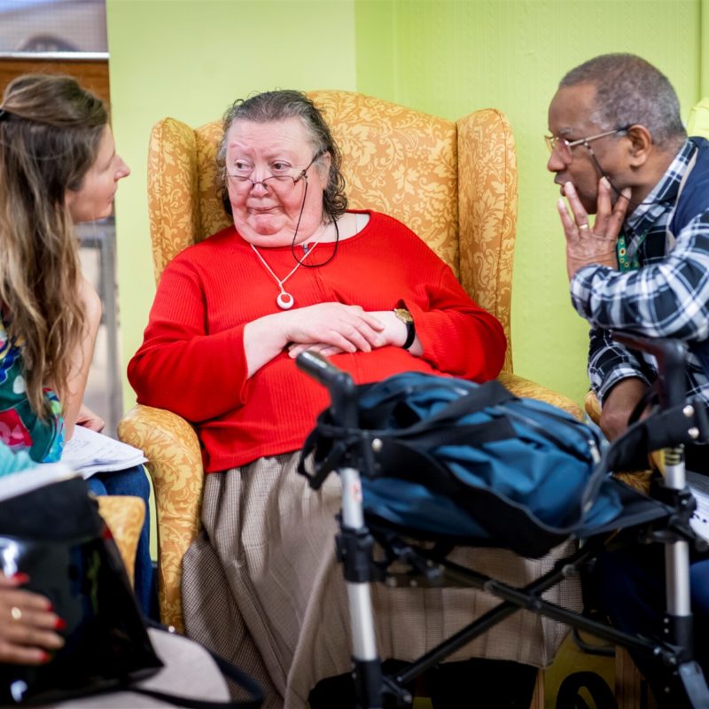 Three older people talking together