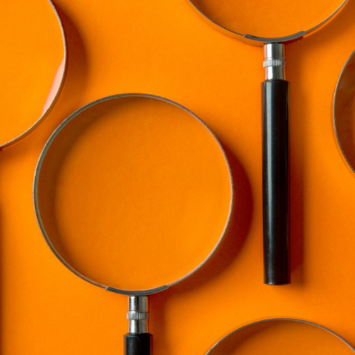 Magnifying glasses on an orange background