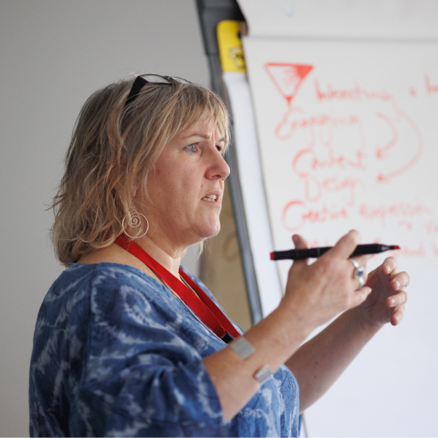 Photo of woman directing a meeting